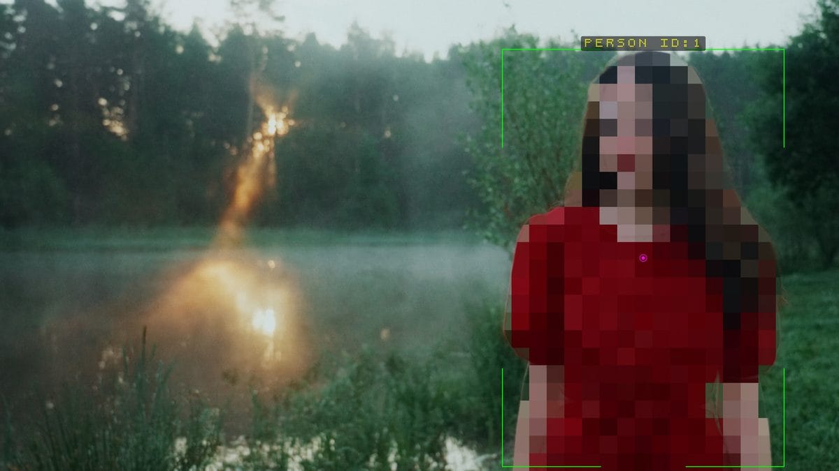 Pixelate following the segmentation outline of a woman by a lake