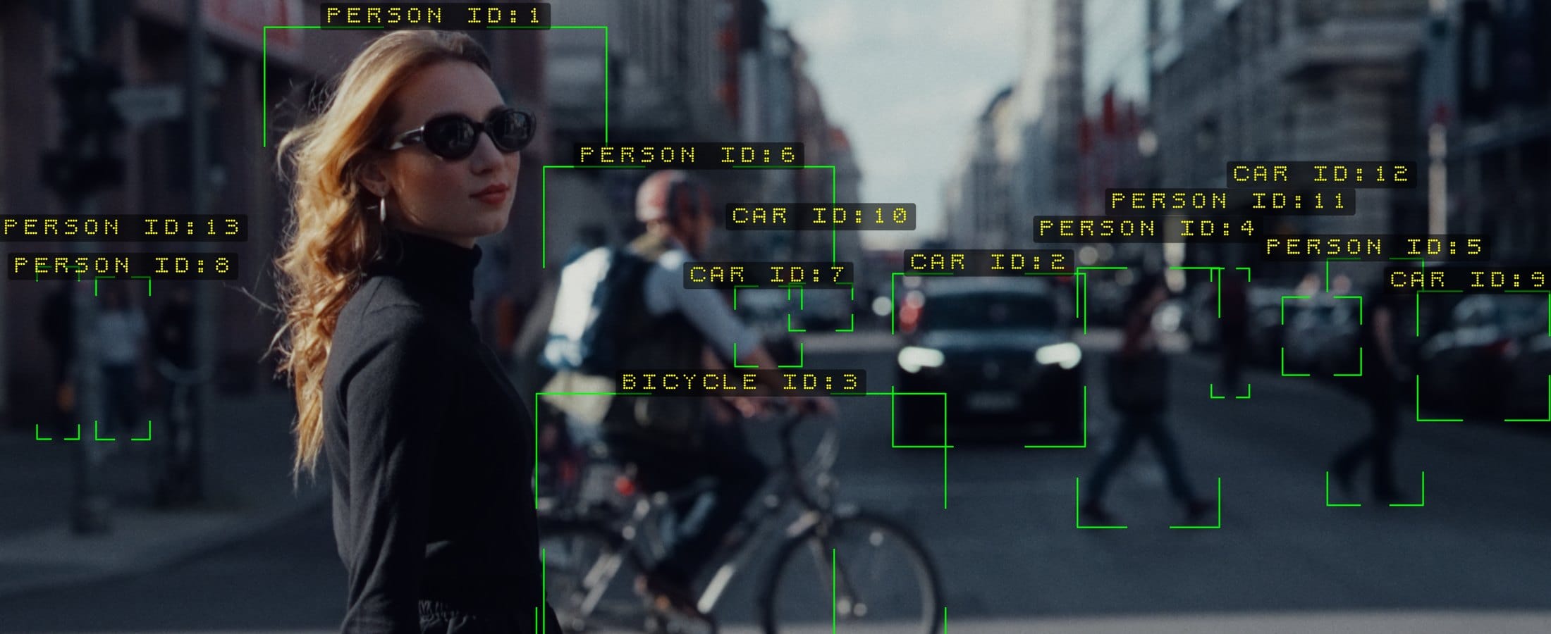 Nx Nexus tracking thirteen subjects on a city street - corner brackets and a label on every person, car and bicycle