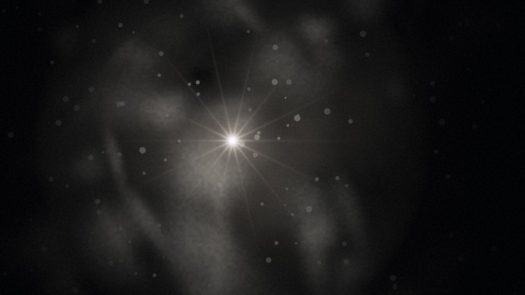 A bright light revealing dust and smudges on the lens
